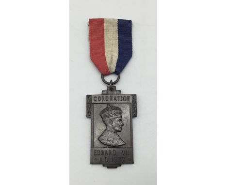 A scarce bronze 1937 Edward VIII coronation medal, complete with its original red, white and blue ribbon. A good quality and 
