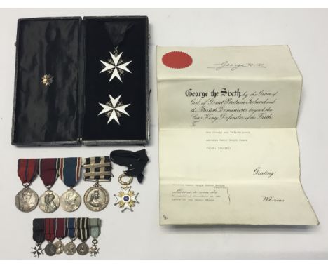 A pre-WW2 era Order of St John Knight of Grace cased insignia set, Latvian Order of the Three Stars, and various Coronation /