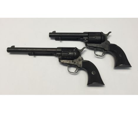 A similar pair of modern inert model Colt single-action Army revolvers by TRC in plain black with moving components and plast
