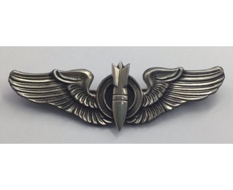 A U.S. Army Airforce sterling silver bombardier’s badge. A heavy gauge die struck example, with separately applied bomb motif