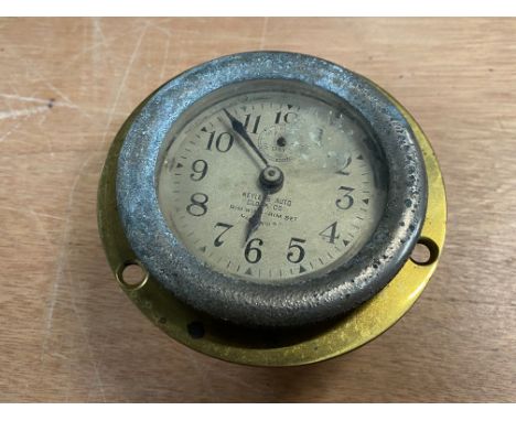 A Keyless Auto Clock Co. rim wind car clock with backing case.
