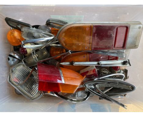 A box of lights, lenses, chrome light trim etc. 
