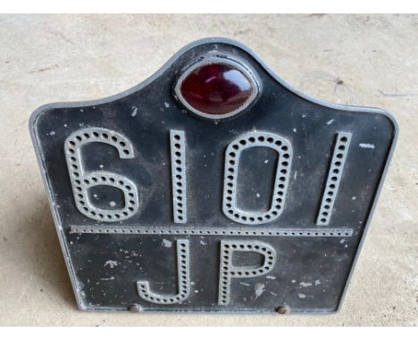 An aluminium number plate with integral lamp for reg. no. 6101 JP.