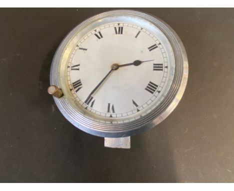A Jaeger type eight day car clock with ribbed aluminium rim. 