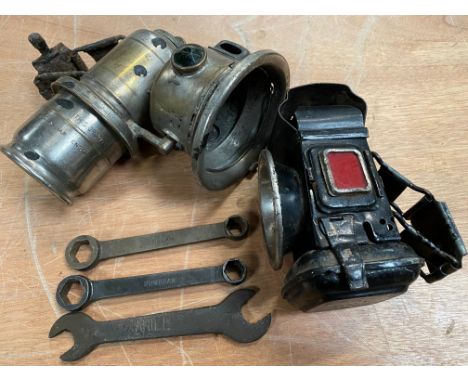 An Ariel motorcycle spanner, two double ended hexagonal Sunbeam spanners, a Lucas motorcycle paraffin lamp and one other. 