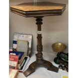 A dark wood wine table with hexagonal top