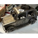 A novelty steel wine bottle holder in the shape of a London taxi