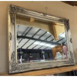 An ornate silver coloured bevel edged mirror (64 x 84cm) COLLECT ONLY