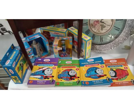 A quantity of Thomas the Tank engine toys, new in boxes &amp; good lot of activity books