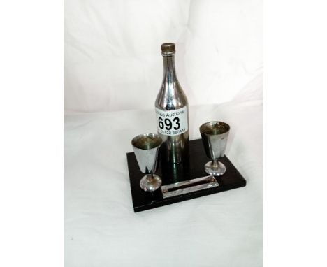 An art deco striker lighter of a champagne bottle &amp; goblets