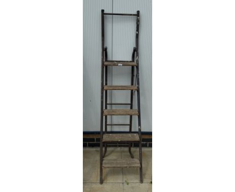 A vintage step ladder with wooden steps