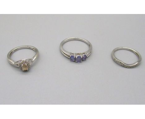9ct white gold ring set with light blue stones, and two other 9ct white gold rings set with coloured stones, all stamped 375,