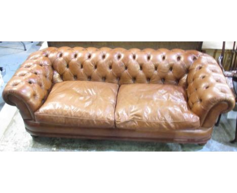 Chesterfield type sofa, upholstered in deep buttoned brown leather with loose seat cushion, W210cm D95cm H67cm 