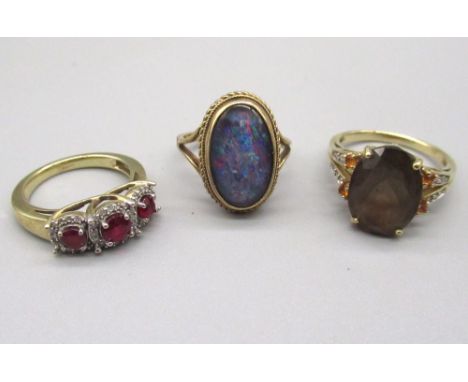 9ct yellow gold ring set with faux opal, and two other 9ct gold rings set with coloured stones, all stamped 375, 12.0g 