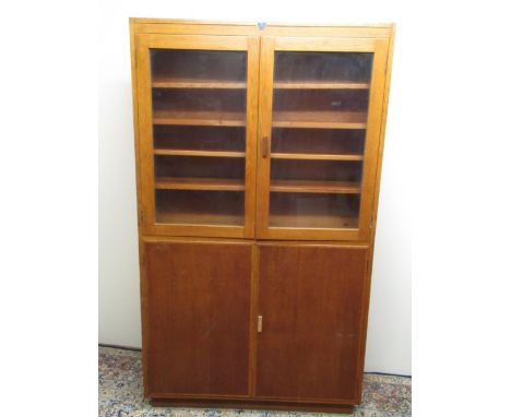 C20th light oak bookcase with two glazed and two panel doors, W108cm D30cm H188cm 