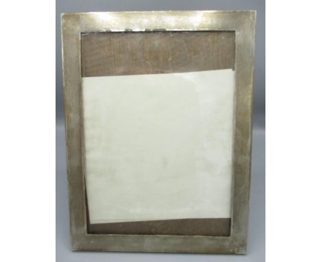 George V silver engine turned easel photograph frame, oak back, hallmarked Birmingham 1919, 25.6cm x 33.4cm 