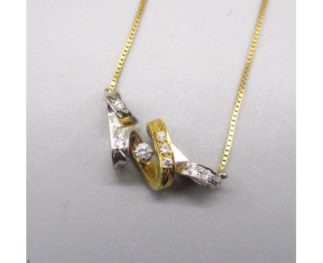 18ct yellow and white gold twisted pendant set with nine brilliant cut diamonds, on 18ct yellow gold chain, stamped 750, L48c