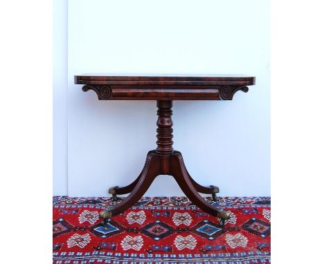 19th century mahogany card table, the rounded rectangular hinged top enclosing baize playing surface, scroll-carved frieze ra