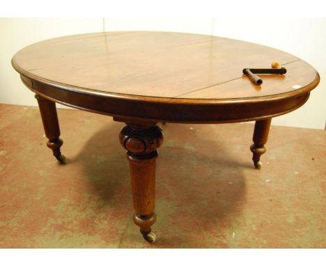 Victorian mahogany oval extending dining table, the moulded top over beaded frieze, raised on tapering turned legs and cerami