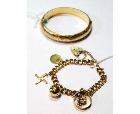 9ct gold double curb bracelet with various charms, 24g, also a rolled gold hinged bangle. 