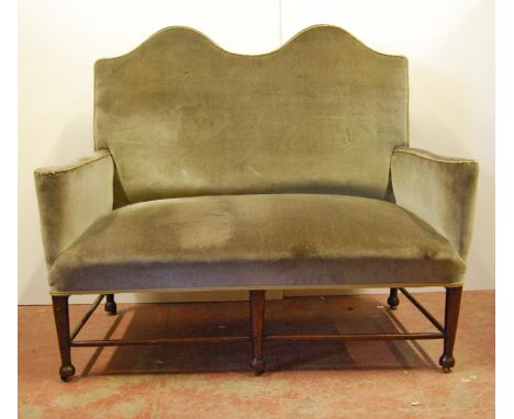 Edwardian Aesthetic-style high-back two-seater sofa, the serpentine cushioned back flanked by arms, stuff-over seat, raised o