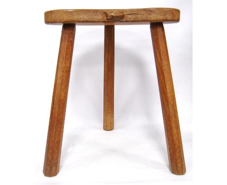 Oak milking stool by Robert 'Mouseman' Thompson, the shaped seat carved with a mouse, on splayed octagonal legs, 42cm wide, a