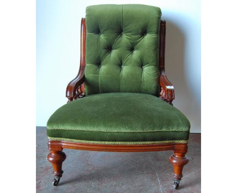 Victorian mahogany lady's button-back chair with downswept arms, cushioned seat, raised on tapering turned legs terminating i