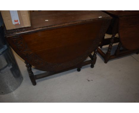 An early 20th Century oak twist gate leg table having chop carved decoration