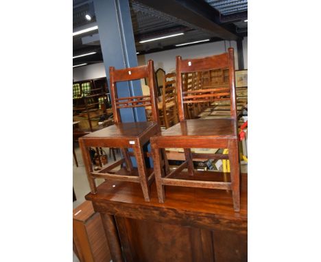 A pair of stained frame solid seat dining chairs having rail and bobbin back