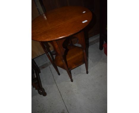 An Arts and Crafts side table having Circular top and hexagonal undertier on file legs, probably Liberty's