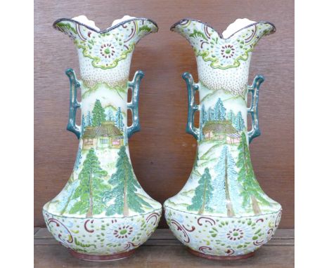 A pair of early 20th Century continental vases decorated in enamel, 30.5cm 