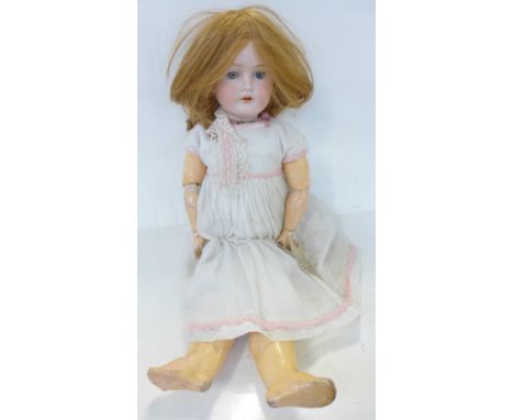 A German C M Bergman bisque head doll with blue open eyes, 1916-8 identification mark, circa 1916, 59cm 