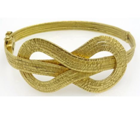 18ct gold hinged bangle, love knot design, stamped 750, approx 23.6gm Condition Report Click here for further images, conditi