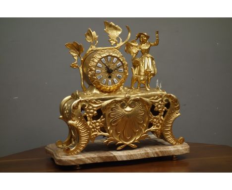 Late 20th century gilt metal figural mantel clock, decorated with scrolls and shell motifs, on serpentine moulded plinth, W38