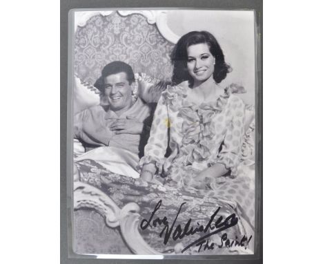From the collection of Valerie Leon - The Saint - a laminated photograph of Leon alongside Roger Moore in ' The Saint '. As u