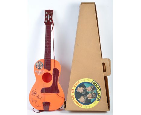 A rare vintage 1960's (1964) Selcol made The Beatles ' Big 6 ' plastic acoustic model guitar. Burgundy, red and orange plasti