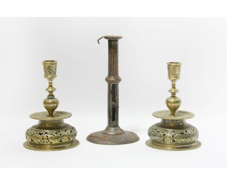 A pair of 16th century style brass candlesticks, 19cm, and an iron 'hog scraper' candlestick, tallest 24cm