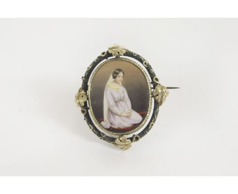 A Victorian silver and gold enamel brooch, of a young woman kneeling on a mother of pearl back