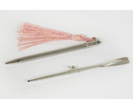 A silver self propelling pencil in the form of an oar, together with a silver self propelling pencil with engine turned decor