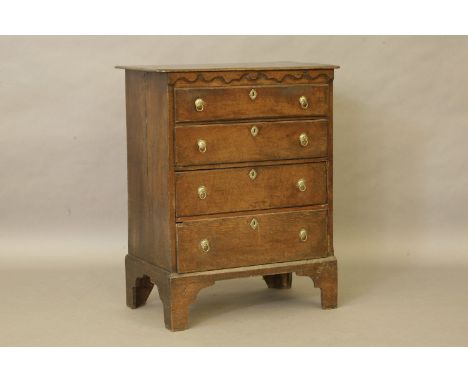 An 18th century oak chest, moulded decoration, brass ring handles on tall bracket feet, 82 x 103 x 49cm