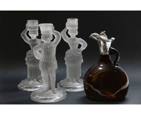 Three Baccarat moulded glass candlesticks, 24.5cm high, and a wine/claret bottle