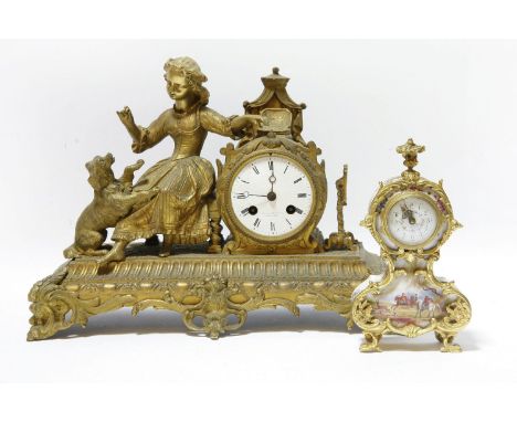 A gilt metal mantle clock, the case mounted with the figure of a seated girl feeding a small dog, the white enamel dial, with
