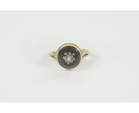 A gold garnet cabochon stick pin converted to a ring, set with seed pearl3.52g size M