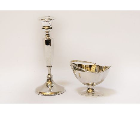 A silver swing handled sugar basket, London 1916, and a loaded candlestick, 20.5cm high