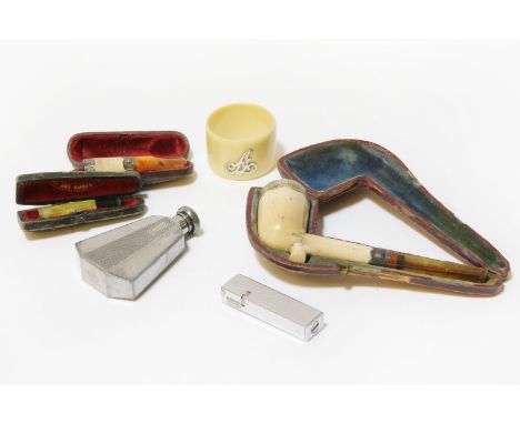 A Meerschaum pipe, cased, cheroot holders, a lighter and a napkin ring