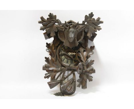 A 19th century black Forest cuckoo clock, heavily carved, fitted eight day movement, 60cm high