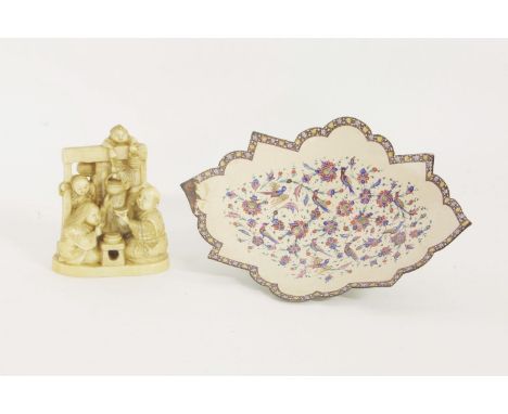 A late 19th century ivory Okimono figural group, together with a Persian enamel dish