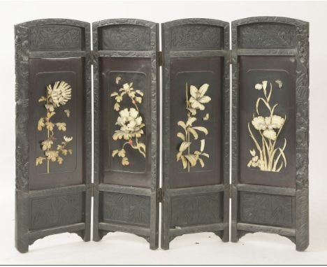 A blackwood four-fold screen, circa1880, each panel applied with relief carved bone flowers and butterflies within a carved f