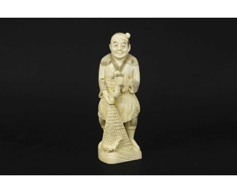 An early 20th Century Japanese ivory okimono of a fisherman, signed to base, 15.5cm high