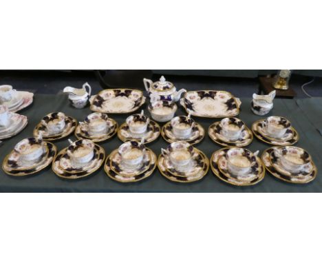 A Coalport Cobalt Blue Tea Service Comprising of Twelve Trios, Two Cream Jugs, Two Cake Plates, Sugar Bowl and Teapot (Y.2665